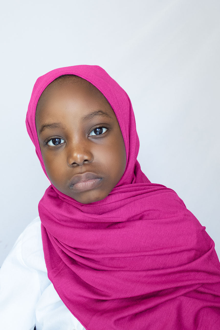 little girl is wearing pink hijab